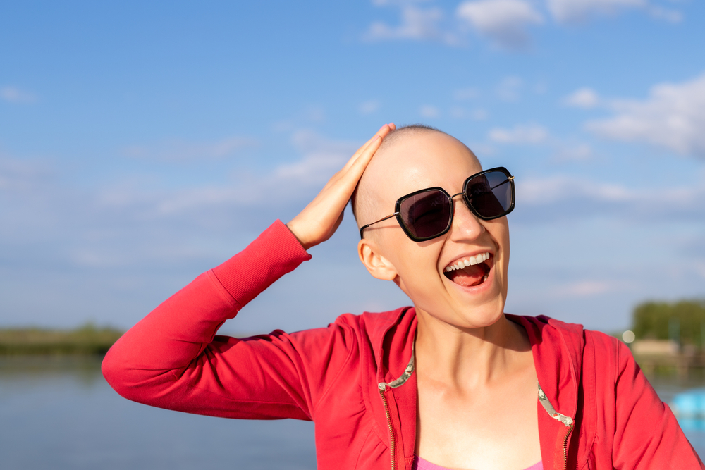 smiling woman with chemo-induced alopecia hair loss